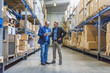 © Westend61 - Two managers discussing packaging and shipment in storage hall