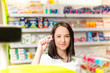 © tibor13 - Pharmacist chemist woman show a pill. Pharmacy drugstore is background. Pretty, young woman. Pharmaceutical.