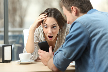 Poster - Surprised woman watching media in a smart phone