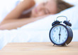 © lenets_tan - Young sleeping woman and alarm clock in bedroom at home