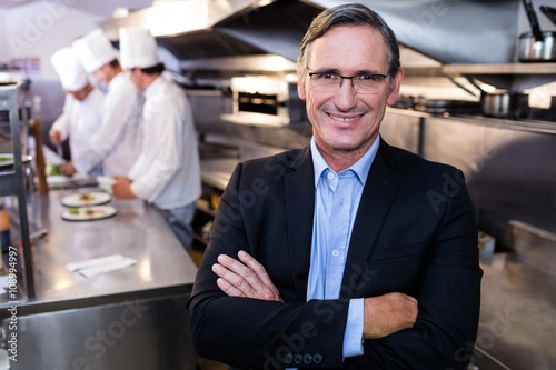 Fotografie, Obraz Male restaurant manager standing with arms crossed