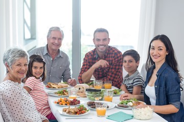 Wall Mural - Happy family having breakfast