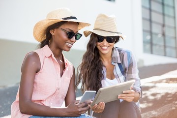 Aufkleber - Young women using digital tablet and mobile phone