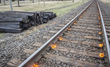 Horizontal Image Of Railroad Ties Lying Beside The Tracks Ready To Be Changed.