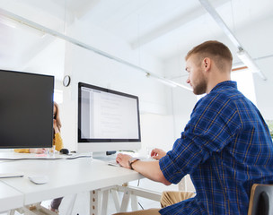 creative man or programmer with computer at office