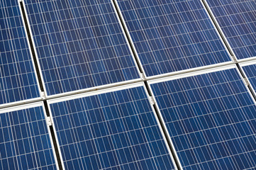 solar panels blue grid with metal frames in a full-frame background close-up