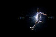 © 103tnn - Soccer player in action over black background