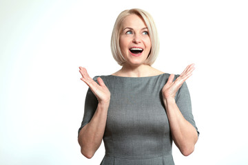 Wall Mural - surprised happy woman looking sideways in excitement. isolated over white background