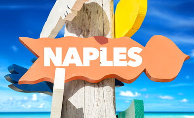Wall Mural - Naples signpost with beach background