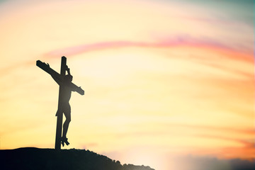 Wall Mural - Silhouette of Jesus with Cross over calvary sunset concept for religion, worship, Christmas, Good Friday, Easter, Jesus he is risen, Thanksgiving prayer and praise, resurrection sunday