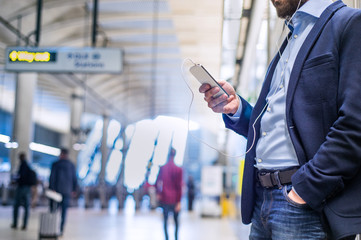 close up of hipster businessman with smartphone, subway station