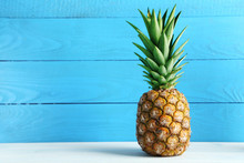 Ripe Pineapple On A White Wooden Table