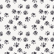 Vector seamless pattern with paw footprints of a dog