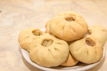 Bashkir national cuisine, homemade meat pies in white plate on a table