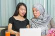 © creativefamily - Asian and muslim girls working on a laptop