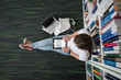 © .shock - female student study in library, using tablet and searching for
