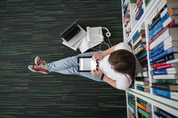 Poster - female student study in library, using tablet and searching for