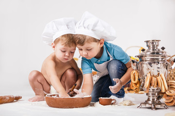 Little girl and funny boy wearing chef hats 