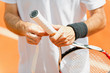 Putting new grip tape on tennis racket