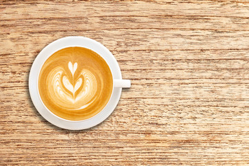 Cup of coffee latte art on wood background.Copy space