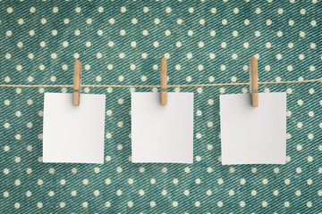 three blank papers hanging with clothespin