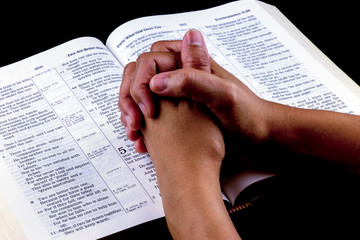 Praying Hands on Open Bible