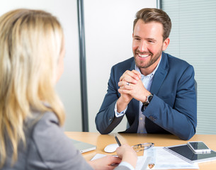 Young attractive employer doing a job interview to a woman