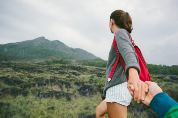 Brave and romantic woman guiding traveler into the wild (intentional pale color style)