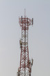 Telecommunication tower and antenna against the sky background.