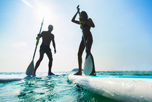 Stand Up Paddle Board Couple Paddleboarding . Young Caucasian Couple On Thailand Beach On Summer Holidays Vacation Travel.