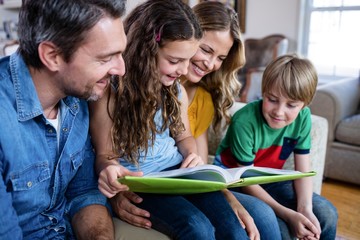 Happy family looking at a photo album