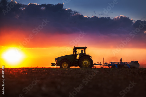 Fotografía Granjero en tractor preparando la tierra con cultivador de semillero