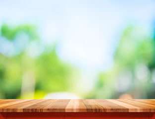 Aufkleber - Empty brown wood table top with sun and blur green tree bokeh ba