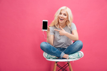 Wall Mural - Woman showing blank smartphone screen