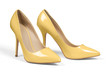 A pair of yellow high heel shoes isolated on white with clipping path.