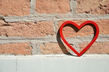 Red Heart Figure On Brick Wall On Day Light