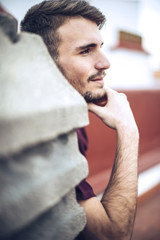 Wall Mural - Handsome caucasian young man in casual clothes in urban environm