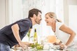© Connect Images - Mature couple leaning over glass table, face to face, laughing