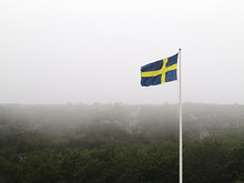 Swedish Flag At Foggy Day