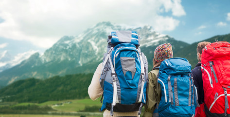 Wall Mural - travelers with backpacks hiking in mountains