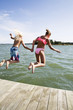 © Johnér - Boy and girl jumping into water