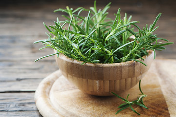 Wall Mural - Fresh green rosemary on the wooden table