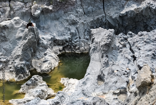 Fotografie, Obraz The river Simeto across an ancient lava flow near Adrano