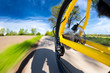 dynamic rear view of fast yellow bicycle mountain bike in front of blue cloudy sky / mountainbike fahrrad schnell und dynamisch vor blauem himmel