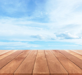Wall Mural - Wood table top on blue sky with clouds - used for display your products