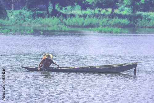 Fotografie, Obraz A way of life of villager netting for fish on the river in the urban , of Thail