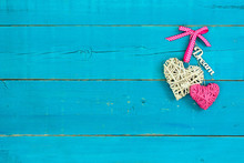 Hearts And Dream Hanging By Pink Ribbon On Teal Blue Background