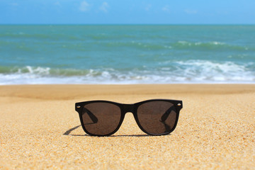 Wall Mural - Black sunglasses on the beach