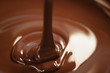 © GCapture - melted dark chocolate flows closeup, shallow focus
