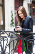 © patrisyu - Female shopper texting